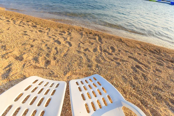 Two beachchairs on the sand near sea, closeup — Stock Photo, Image