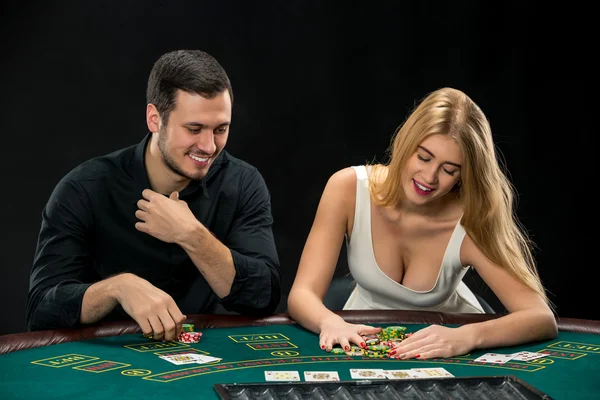 युवा जोड़ी पोकर खेल रही है, महिला जीतने के बाद पोकर चिप्स ले रही है — स्टॉक फ़ोटो, इमेज