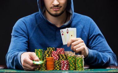 Bir çift as gösterilen poker oyuncusu