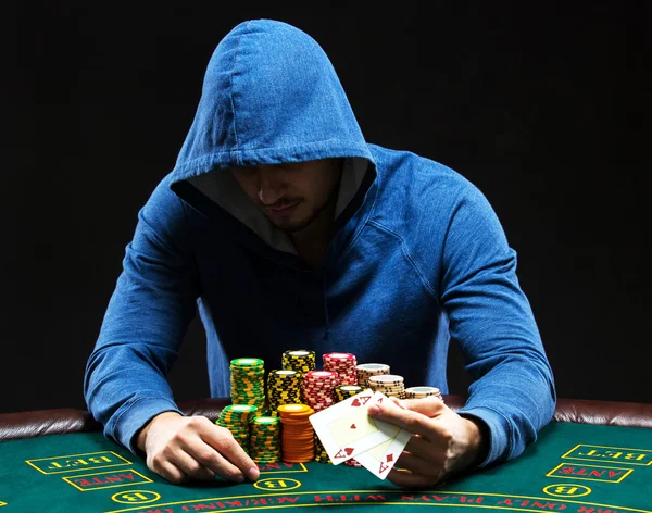 Poker player showing a pair of aces