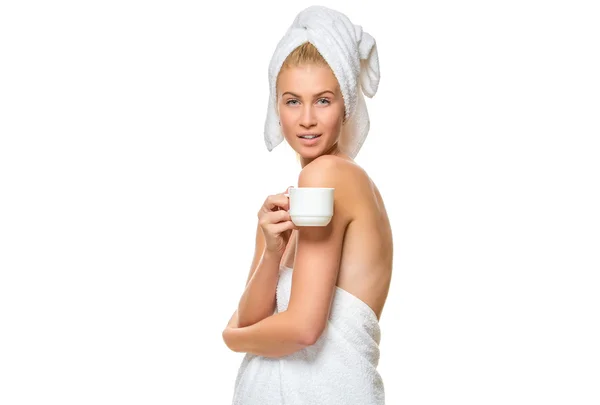 Young woman in towel drinks from a cup — Stock Photo, Image