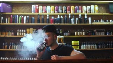 vape Dükkanı satıcı alıcı ve exhaling duman e-sigara göster