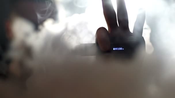 Young vaper man exhaling big clouds of smoke with e-cigarette vape in slowmotion — Stock Video