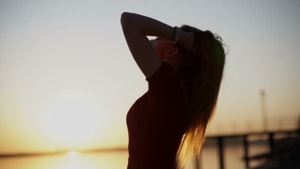 Όμορφη κοπέλα με γυαλιά ηλίου στο ηλιοβασίλεμα χαμογελά στη φωτογραφική μηχανή — Αρχείο Βίντεο