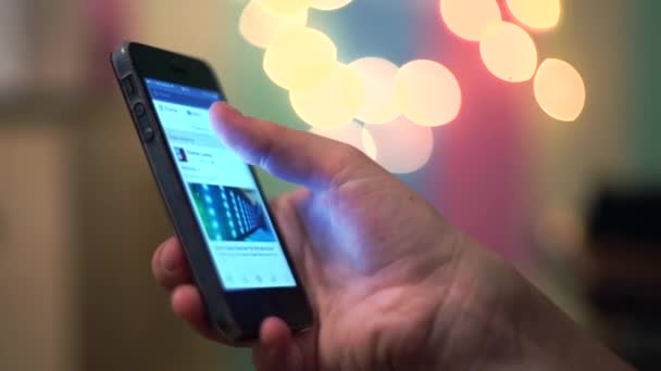 Womens hand using cellphone on the bokeh — Stock Video