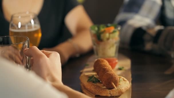 Веселая компания пьет пиво в баре — стоковое видео
