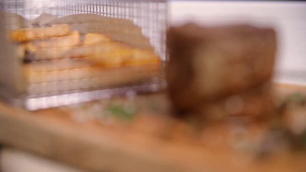 Biftek ve patates kızartması bir ahşap tahta üzerinde — Stok video