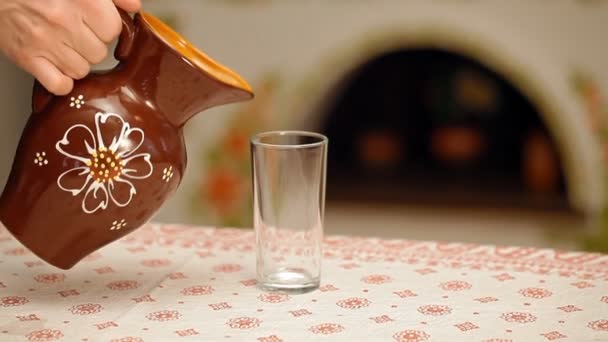 Pouring milk into a glass from a jug — Stock Video