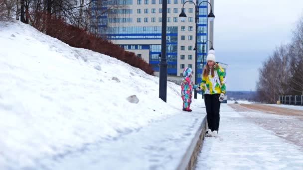 A mother and child are walking on the promenade in winter — Stock Video