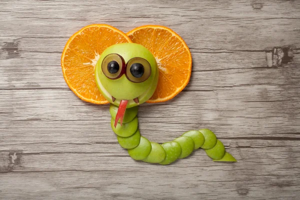 Funny fruit cobra made on wood — Stock Photo, Image