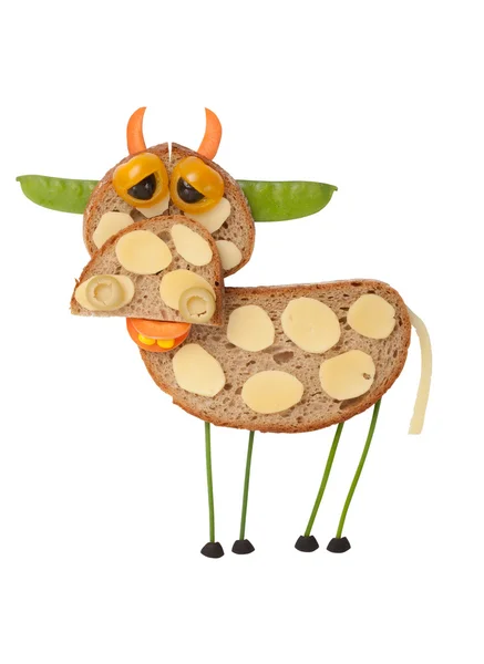 Sad cow made of bread and vegetables — Stock Photo, Image