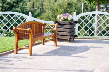 ahşap Bank, beyaz çit ve çiçekler