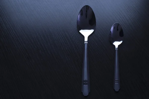 Cutlery on a black table — Stock Photo, Image