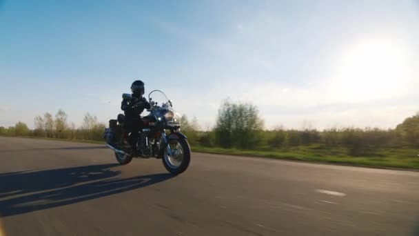 Motocykl jízda na venkovské silnici, slunce svítí na ní