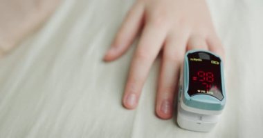 Childs 'ın elinde kalp atış hızı monitörü var. Nabız ve kan oksijeni doygunluğunu ölçüyor. Üst görünüm