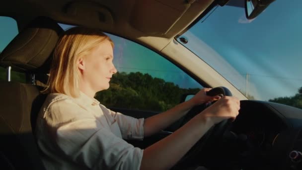 Γυναίκα οδηγός πίσω από το τιμόνι ενός αυτοκινήτου οδηγεί στην εθνική οδό — Αρχείο Βίντεο