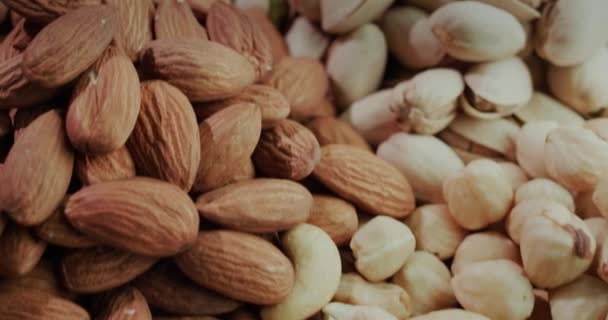 Macro shot: Handfuls of ready-to-eat nuts of different varieties. Slider shot — Stock Video