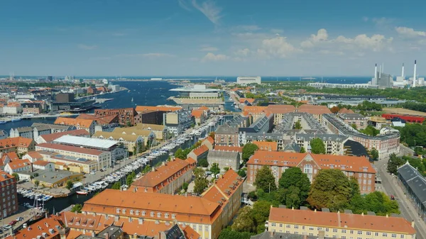 Beautiful city of Copenhagen, view from the heights. Houses with tiled roofs and a river. Pan shot — Stock Photo, Image