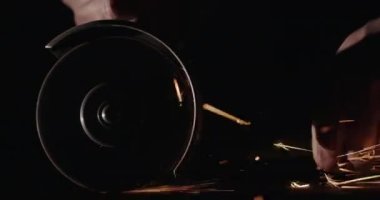 Usta, elle tutulan bir elektro enstrümanla metali tutuyor. Yavaş çekim videosu