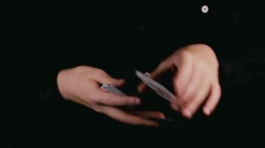 Bir iskambil destesi ile eller büyücü. Siyah arka plan