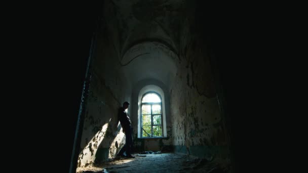 Young man in despair goes to an abandoned house. Concept: job loss, depression, unemployment, despair, grief — Stock Video