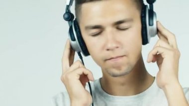 adam beyaz bir arka plan üzerinde kulaklık ile müzik dinlemek