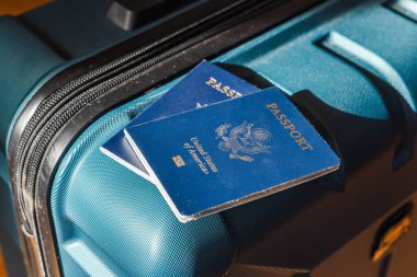 Seyahat çantasına yerleştirilmiş ABD pasaportları uluslararası seyahat için hazırlanıyor.