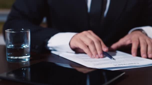 Businessman signs a number of document