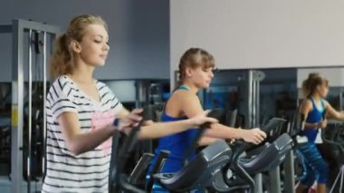 Bir eğitim oturumunda. İki çekici kadın spor salonunda eğitilmiştir