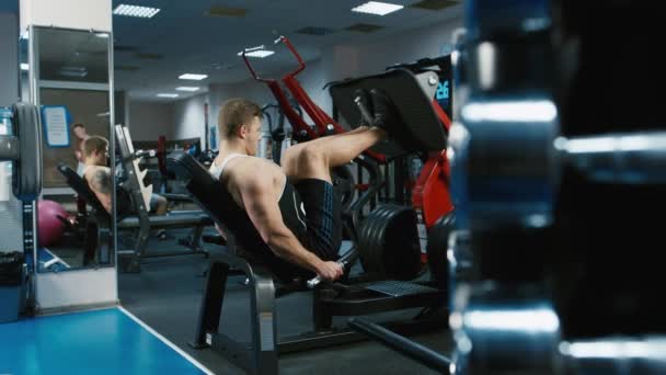 The athlete trains the muscles of the legs in a sports simulator. Shooting with the slider — Stock Video