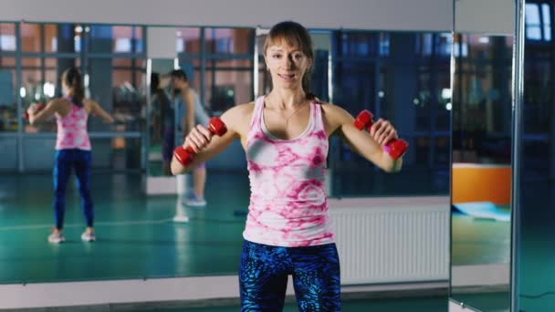 Attractive woman doing exercises with dumbbells — Stock Video