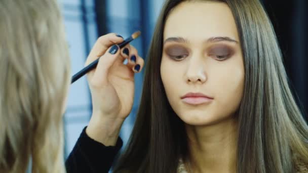 Close-up van een jonge vrouw: waar moeten worden toegepast make-up — Stockvideo