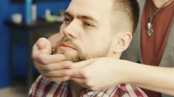 Peluquero frota su barba cliente mantequilla — Vídeos de Stock