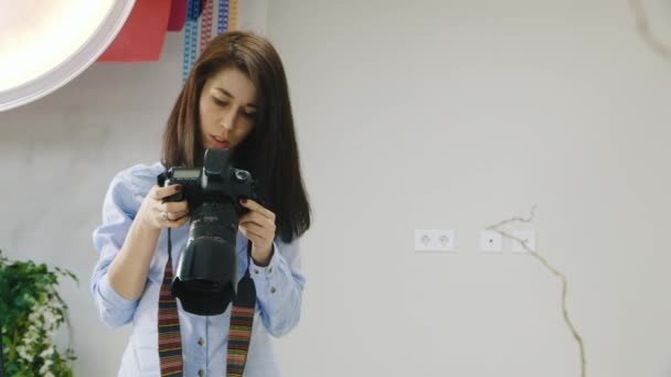 Kvinnlig fotograf arbetar i studion — Stockvideo