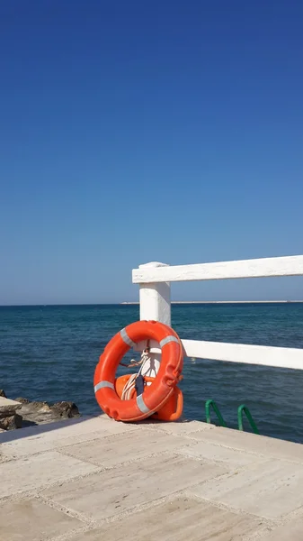 Спасательный круг на мосту у моря — стоковое фото