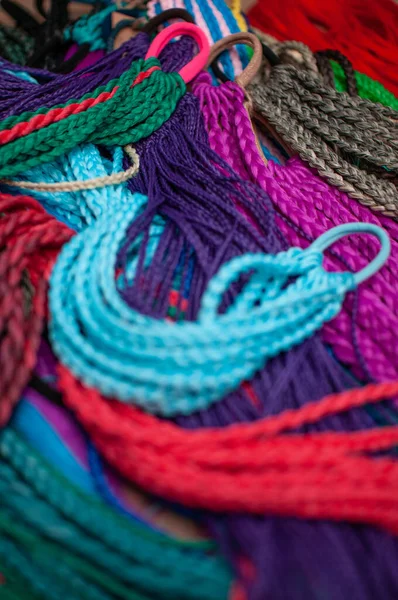 Colored braids on an elastic band for hair, accessory close-up