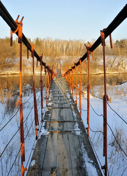 Suspension bridge across the river in winter Chelyabinsk, Russia