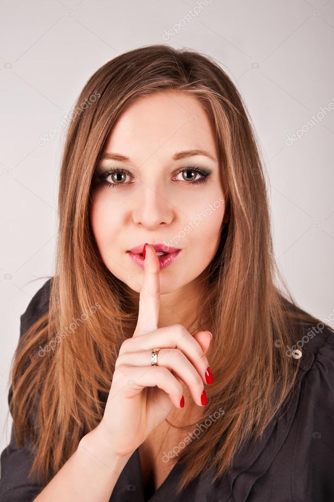Young woman asks for keeping silence by using "shush" sign Stock Photo by ©tzabula 107259434