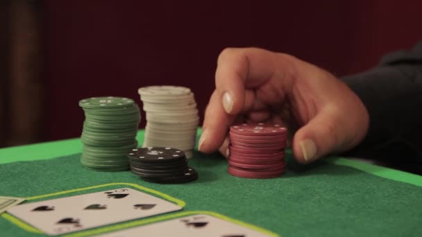 A close-up hand at the gambling table goes through the chips — Stock video