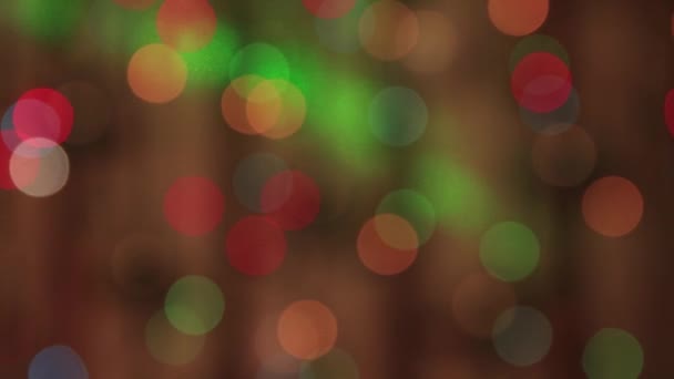 Festive delicate multi-colored lights sway in the dark and a slow green beam. — Stock Video
