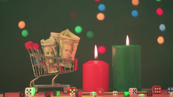 Ein Korb Geld und brennende Weihnachtskerzen mit einem grünen Strahl im Rauch. — Stockvideo