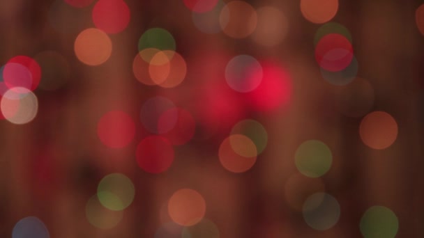 Festive delicate multicolored lights burn in the dark and a slow red ray. — Stock Video