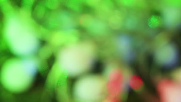 The Christmas green lights and the beam flicker create a beautiful bokeh. — Stockvideo