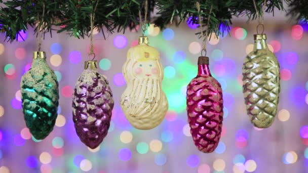 Santa Claus and glass cones hang on a branch on New Years Eve. — Stock Video