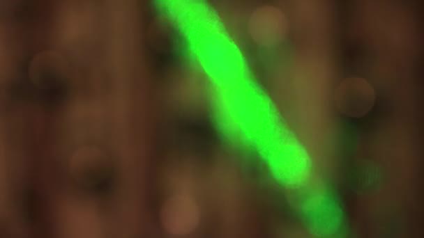 Festive delicate white lights sway in the dark and a fast green beam. — Stock Video