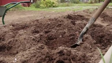 Yakın plan kürek delikte organik gübreyi karıştırır.. 