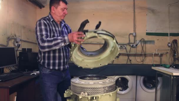 O homem remove a tampa do tambor de plástico e olha para dentro. — Vídeo de Stock