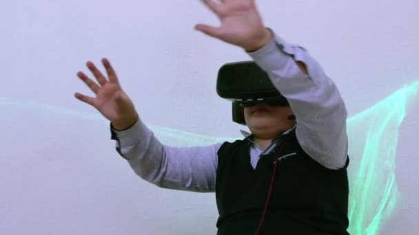 The boy in the augmented reality helmet moves his hands wide. — Stockvideo