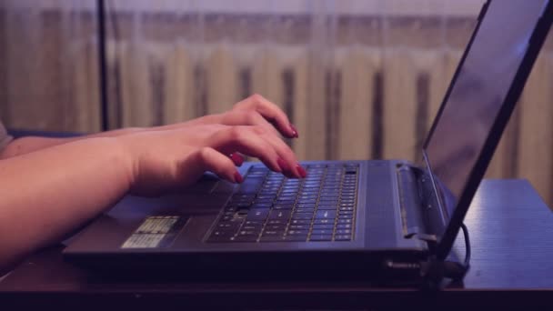 Las manos femeninas están escribiendo en un primer plano del teclado de un ordenador portátil, trabajando desde casa. — Vídeos de Stock