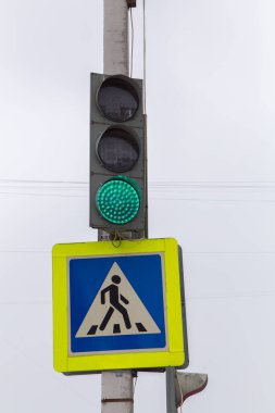 Yeşil trafik ışığı ve yaya geçidi tabelası yanıyor..